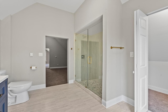 bathroom with vanity, vaulted ceiling, toilet, and walk in shower