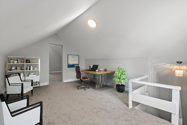 carpeted home office featuring vaulted ceiling