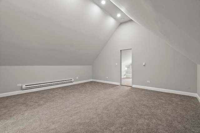 additional living space featuring a baseboard radiator, vaulted ceiling, and carpet flooring