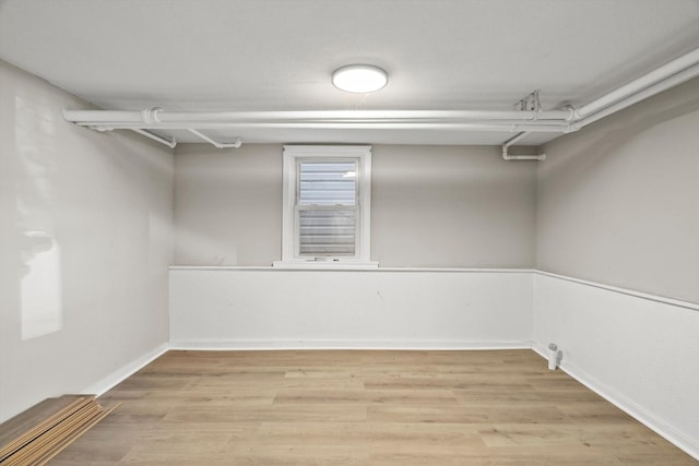 walk in closet with light hardwood / wood-style floors