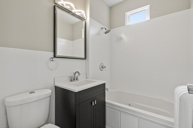 full bathroom with tile walls, vanity, shower / tub combination, and toilet