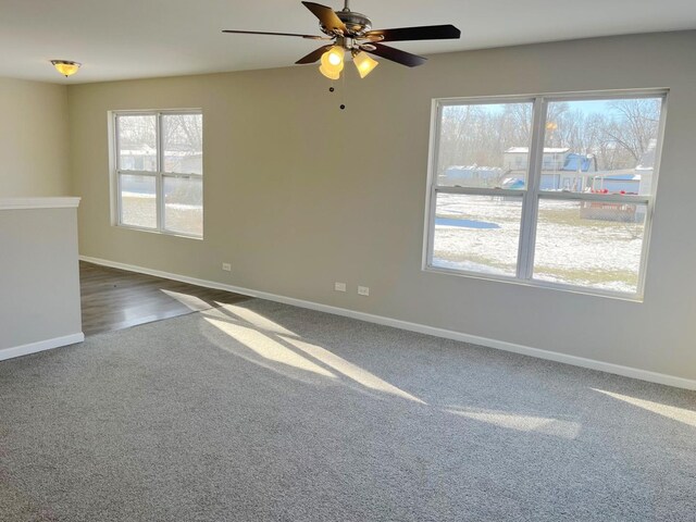 carpeted spare room with ceiling fan