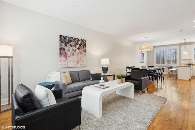 living area with light wood finished floors and baseboards