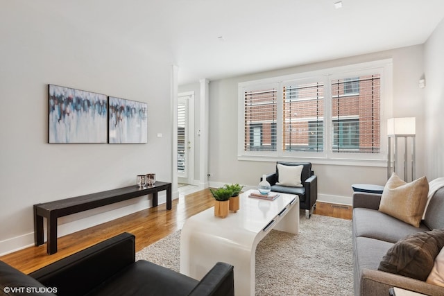 living room with baseboards and wood finished floors