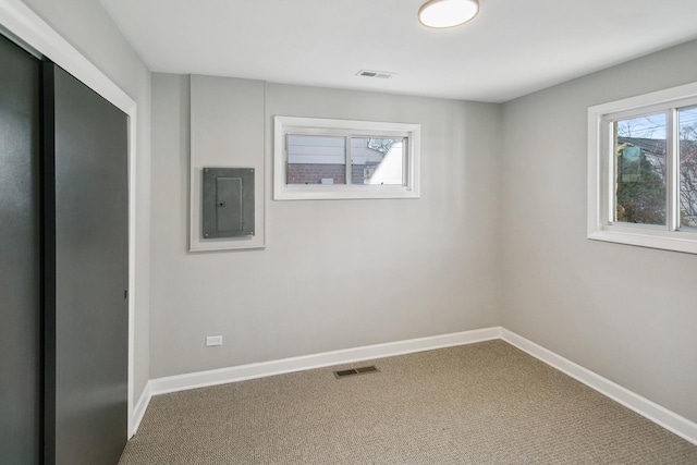 carpeted spare room featuring electric panel