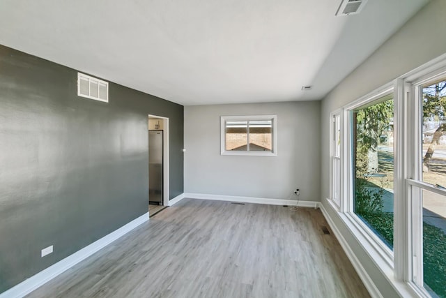 spare room featuring light hardwood / wood-style floors