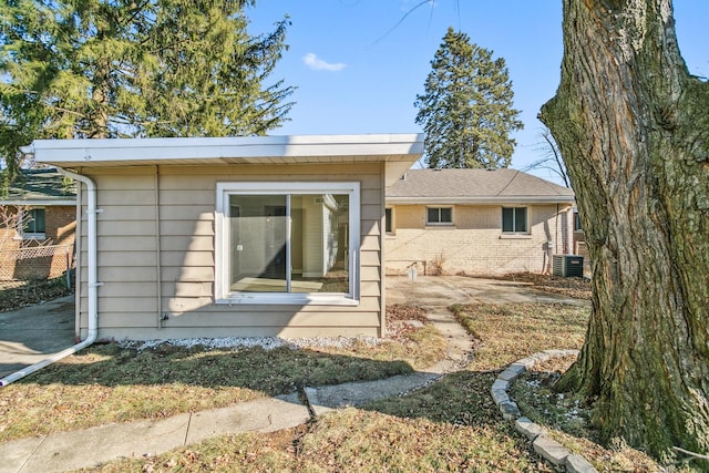 view of front of home featuring cooling unit and a patio area