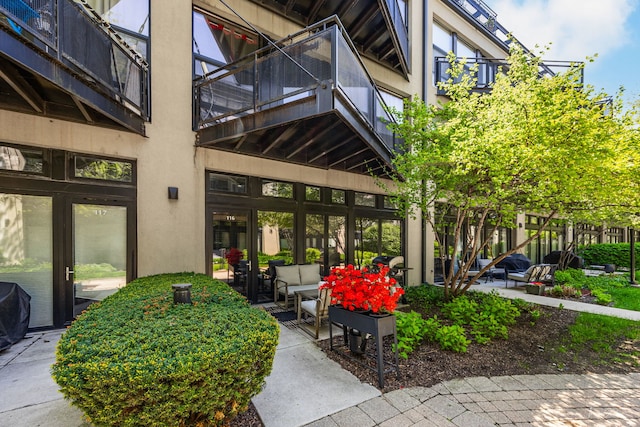 1000 W 15th St Unit 116, Chicago, IL 60608 - entrance to property with a balcony, an outdoor living space, and stucco siding