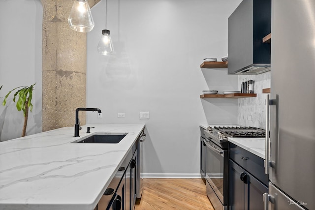 1000 W 15th St Unit 116, Chicago, IL 60608 - kitchen with stainless steel appliances, a sink, open shelves, light stone counters, and light wood-type flooring