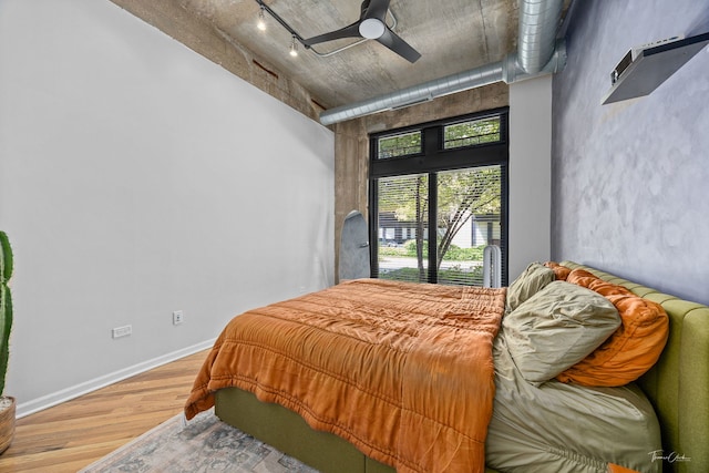 1000 W 15th St Unit 116, Chicago, IL 60608 - bedroom featuring wood finished floors, rail lighting, ceiling fan, and baseboards
