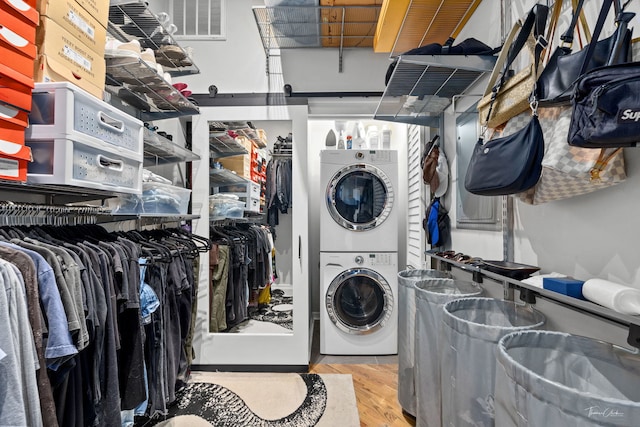 1000 W 15th St Unit 116, Chicago, IL 60608 - washroom featuring stacked washer and clothes dryer and wood finished floors