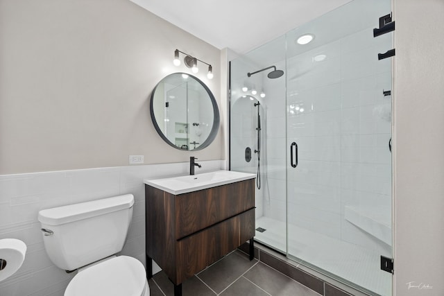 1000 W 15th St Unit 116, Chicago, IL 60608 - bathroom with a stall shower, toilet, tile patterned floors, vanity, and wainscoting