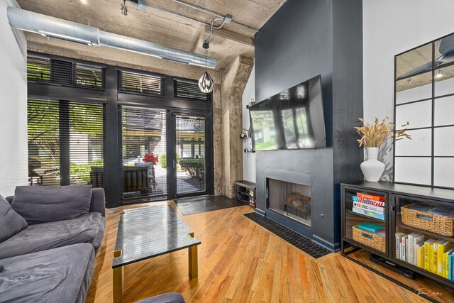 1000 W 15th St Unit 116, Chicago, IL 60608 - living room featuring a fireplace with flush hearth, wood finished floors, and track lighting