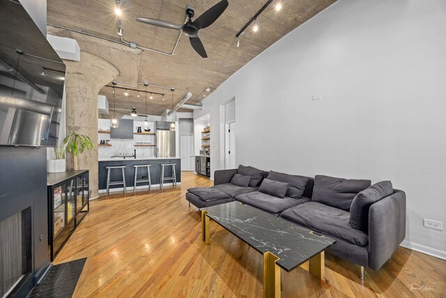 1000 W 15th St Unit 116, Chicago, IL 60608 - living room with rail lighting, a ceiling fan, and light wood-style flooring