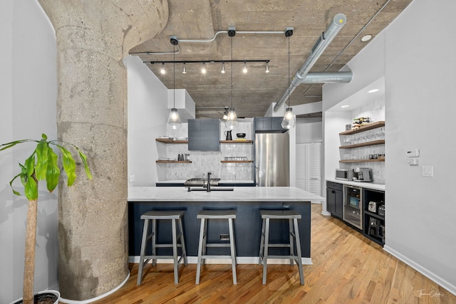 1000 W 15th St Unit 116, Chicago, IL 60608 - kitchen with open shelves, rail lighting, tasteful backsplash, and a sink