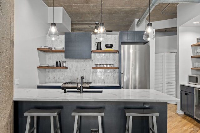 1000 W 15th St Unit 116, Chicago, IL 60608 - kitchen featuring open shelves, appliances with stainless steel finishes, decorative backsplash, and light stone countertops
