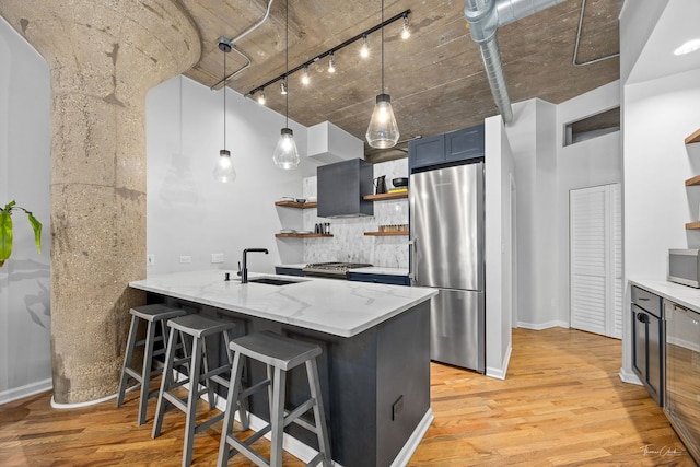 1000 W 15th St Unit 116, Chicago, IL 60608 - kitchen with stainless steel appliances, open shelves, a sink, track lighting, and light stone countertops