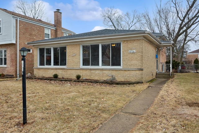 view of side of property with a yard