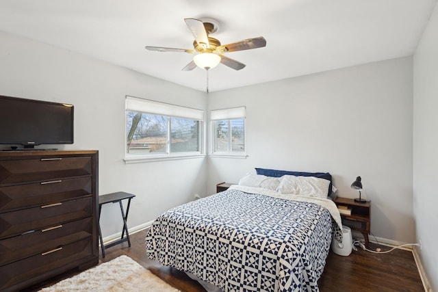 bedroom with dark hardwood / wood-style floors and ceiling fan