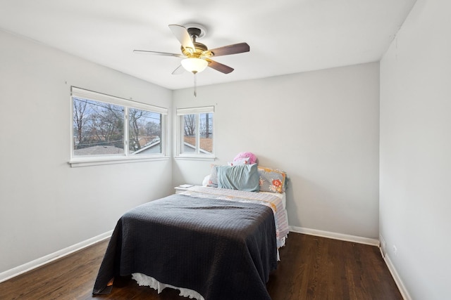 bedroom with ceiling fan and dark hardwood / wood-style floors