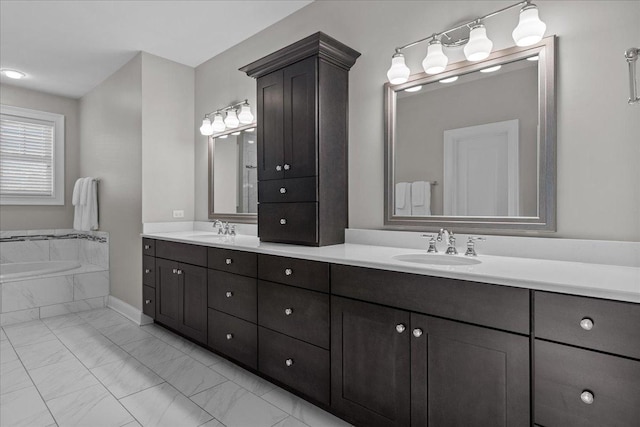 bathroom featuring vanity and tiled tub