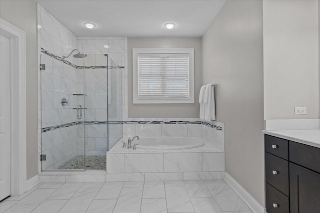 bathroom featuring vanity and separate shower and tub