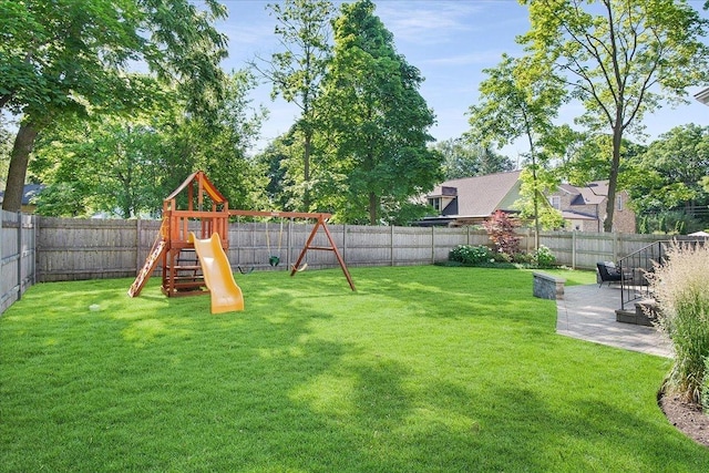 view of yard featuring a playground and a patio area