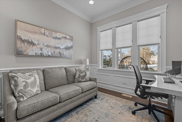 home office featuring hardwood / wood-style flooring, ornamental molding, and a healthy amount of sunlight