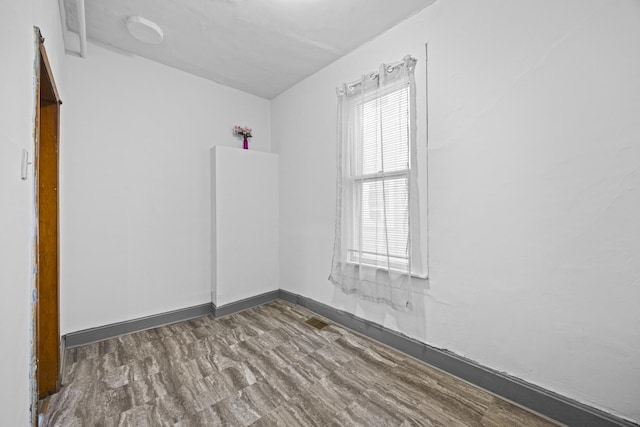 unfurnished room featuring dark hardwood / wood-style floors