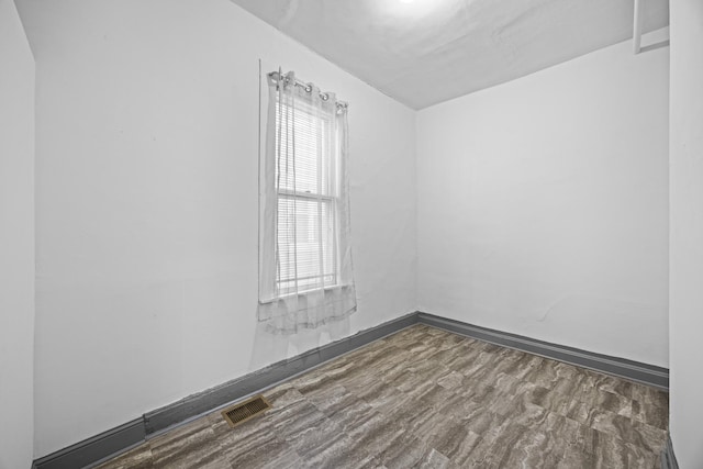 spare room featuring wood-type flooring