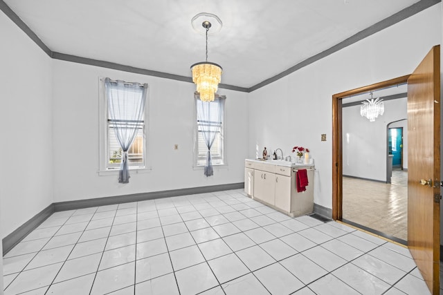 unfurnished room with a notable chandelier, light tile patterned floors, and ornamental molding