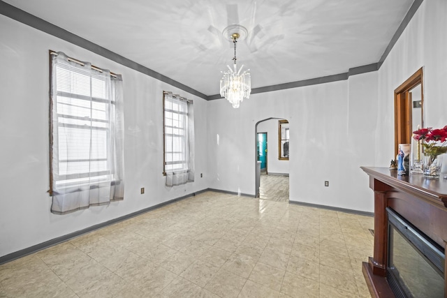 unfurnished room featuring an inviting chandelier