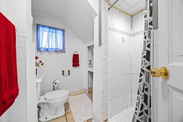 bathroom featuring tile walls, tile patterned flooring, curtained shower, vaulted ceiling, and toilet