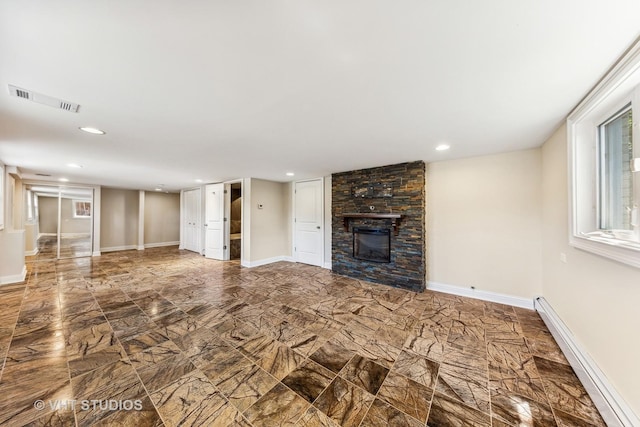 unfurnished living room featuring a fireplace and a baseboard radiator