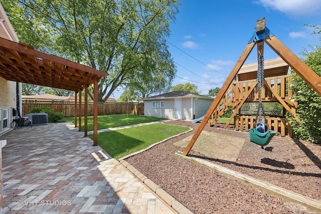 view of yard featuring central AC, a patio, a playground, and a storage unit