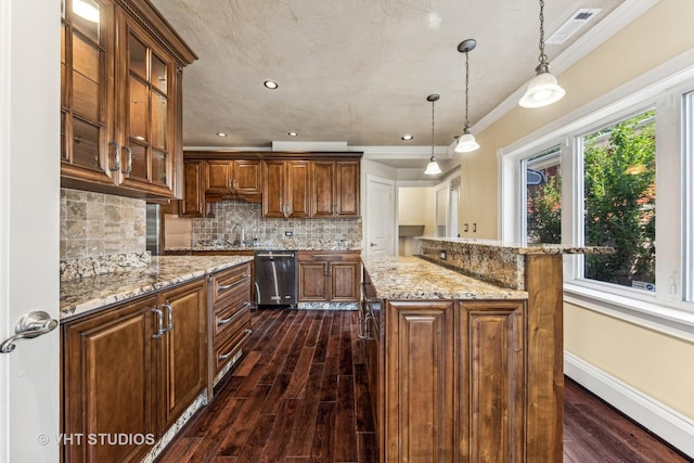 kitchen featuring a kitchen island, dark hardwood / wood-style floors, decorative light fixtures, stainless steel dishwasher, and crown molding