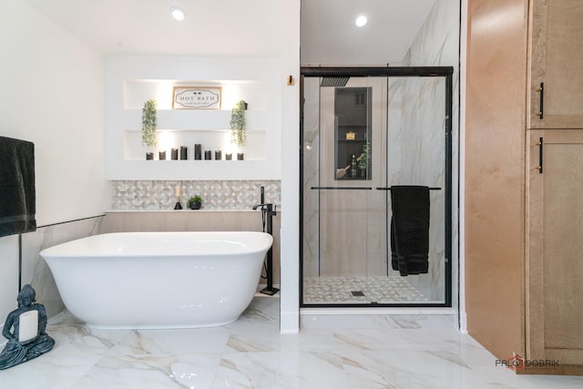 bathroom featuring separate shower and tub