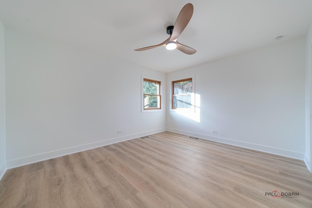 empty room featuring ceiling fan and light wood-type flooring