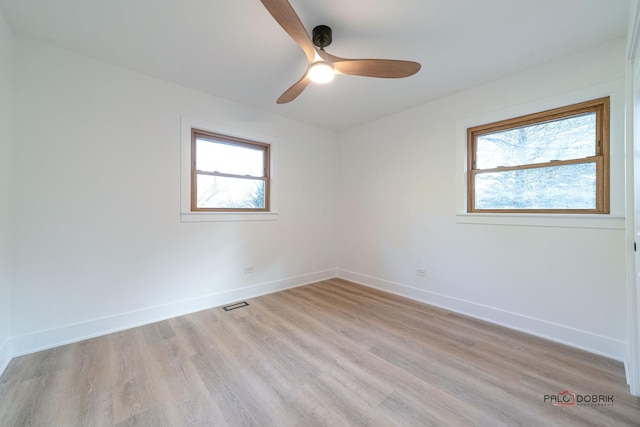 unfurnished room with ceiling fan, light hardwood / wood-style floors, and a wealth of natural light