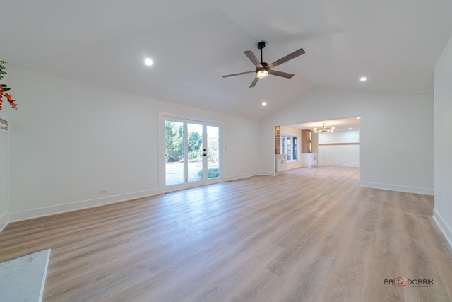 unfurnished living room with high vaulted ceiling, ceiling fan with notable chandelier, and light hardwood / wood-style floors