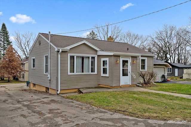 view of front of house with a garage and a front yard