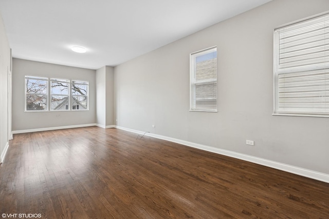 spare room featuring dark wood-type flooring