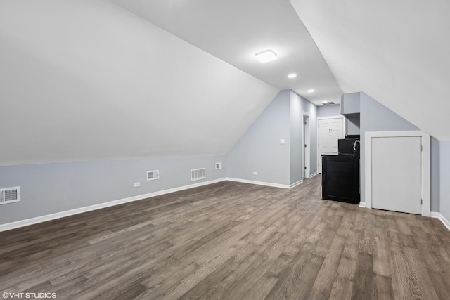 bonus room featuring hardwood / wood-style floors and vaulted ceiling