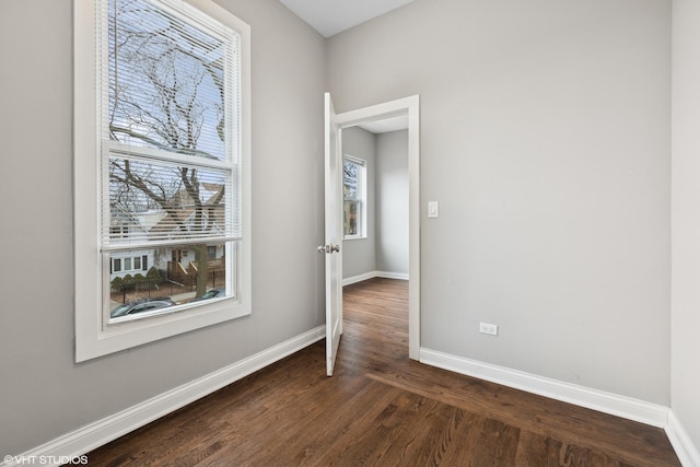 spare room featuring dark wood-type flooring