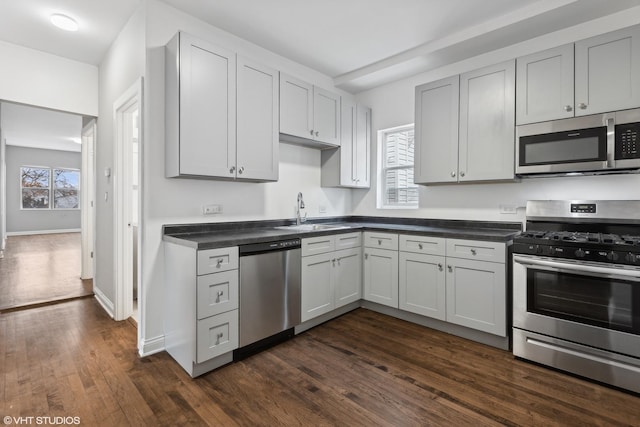 kitchen with stainless steel appliances, dark hardwood / wood-style flooring, sink, and a wealth of natural light