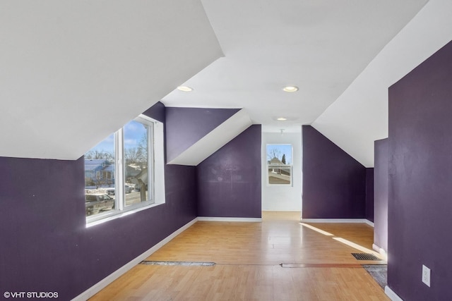 additional living space featuring lofted ceiling and hardwood / wood-style floors