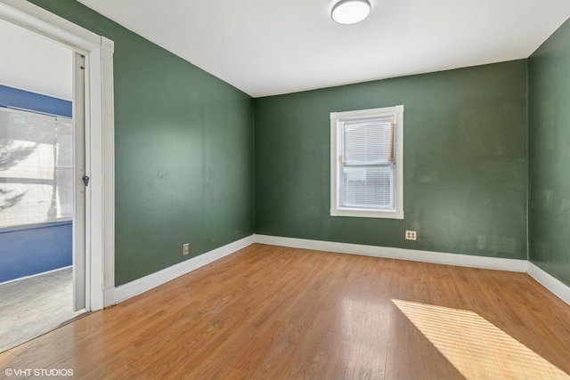 spare room with hardwood / wood-style floors