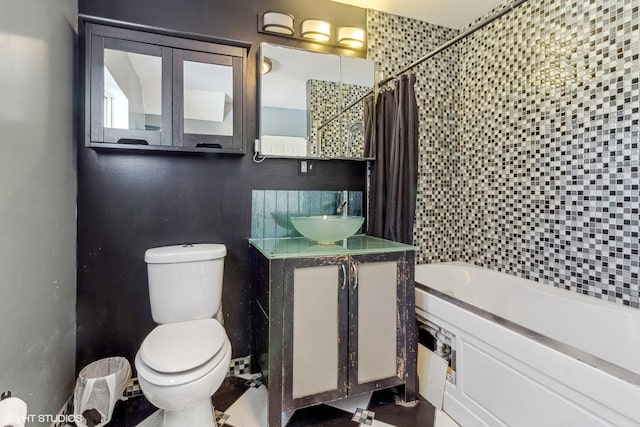 full bathroom with shower / bath combo, vanity, backsplash, and toilet