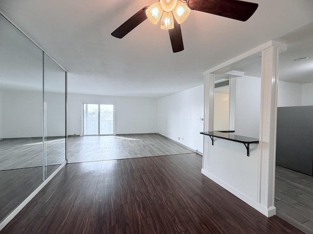 empty room featuring dark hardwood / wood-style floors and ceiling fan