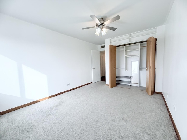 unfurnished bedroom with ceiling fan, light colored carpet, and a closet